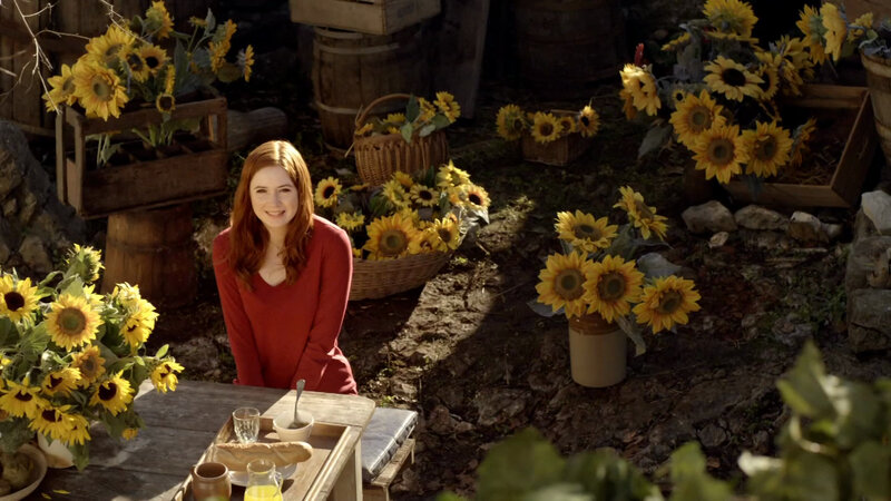 Woman with sunflowers outdoors