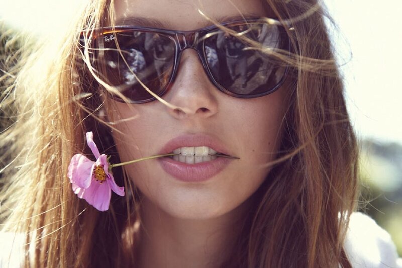 woman with sunglasses and flower