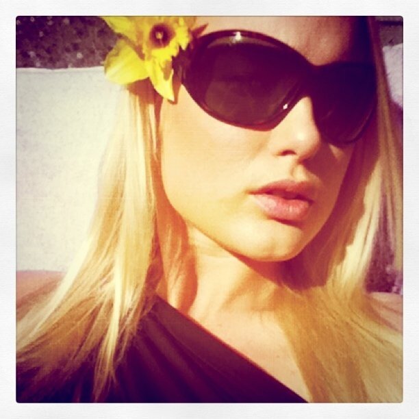 woman with sunglasses and flower