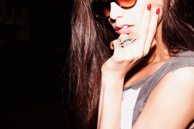 woman with sunglasses and red nails