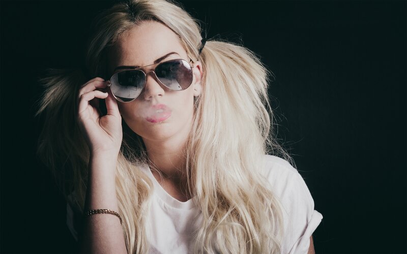 woman with sunglasses and smoke