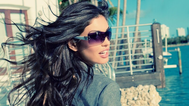 woman with sunglasses by the water