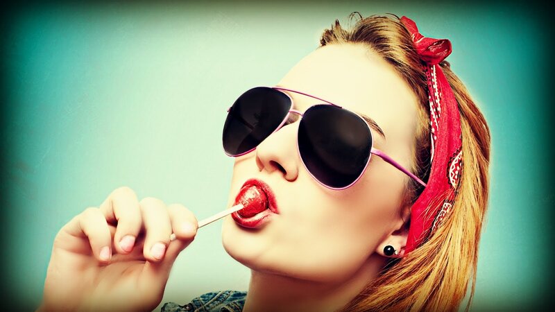 woman with sunglasses eating lollipop