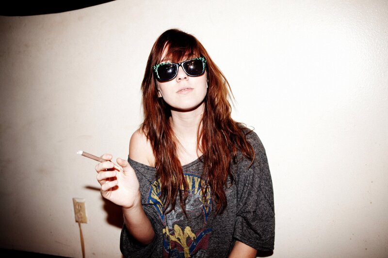 woman with sunglasses holding cigarette