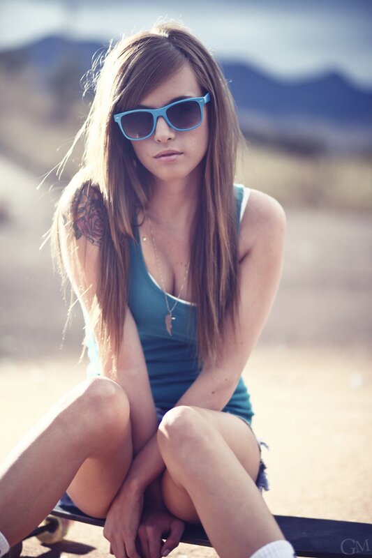 woman with sunglasses on skateboard