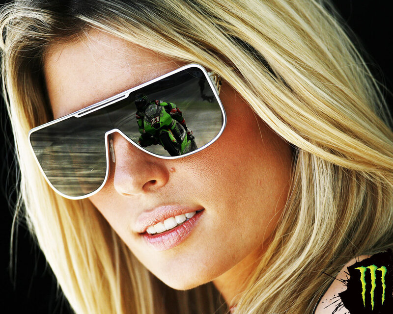 Woman with sunglasses reflecting motorcycle