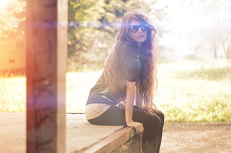 woman with sunglasses sitting outside