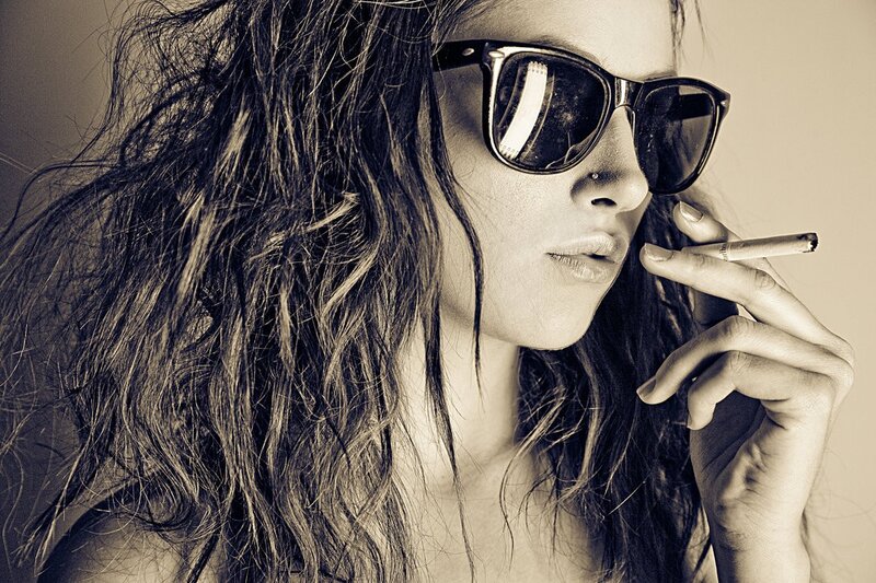 woman with sunglasses smoking cigarette