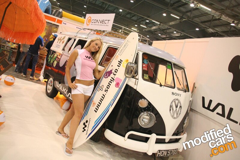 Woman with surfboard and VW van