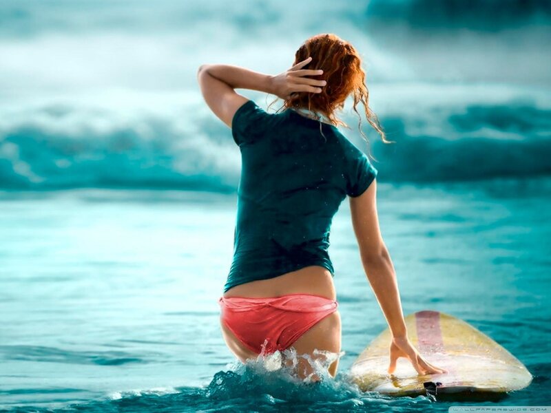 woman with surfboard in ocean