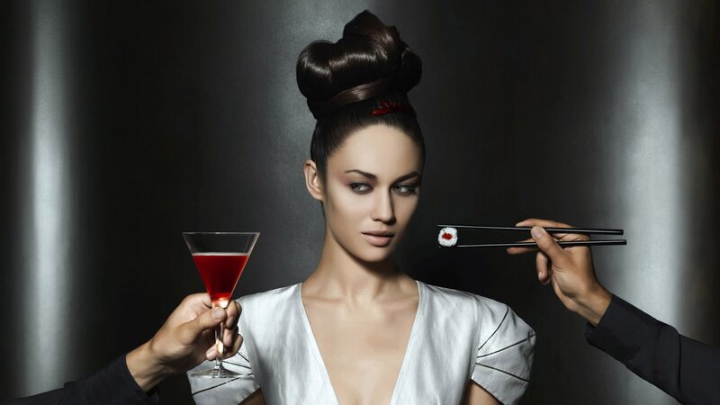 woman with sushi and cocktail