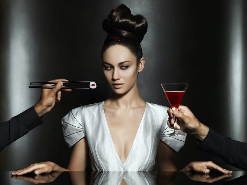 Woman with sushi and cocktail