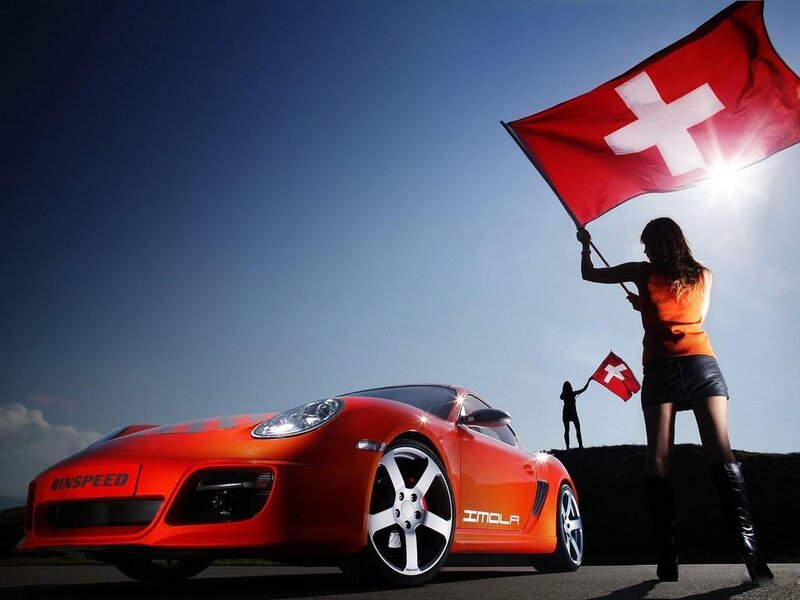 Woman with Swiss flag and red car