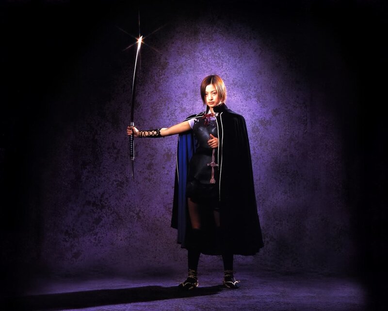 woman with sword in dark cloak