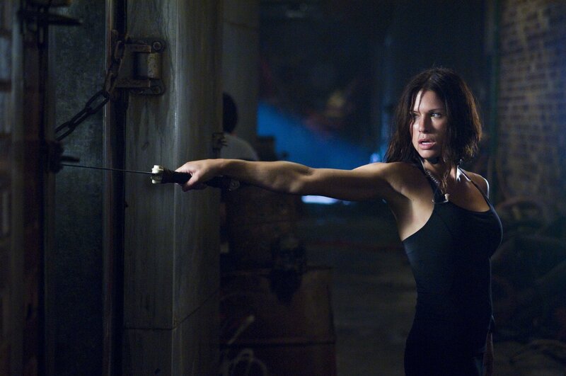 Woman with sword in dark room