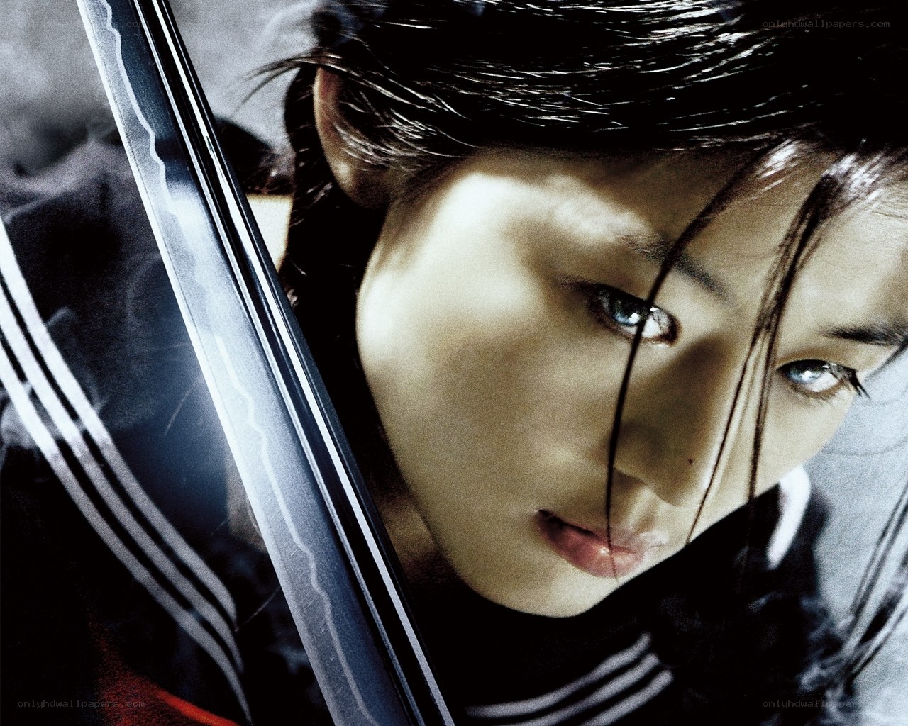 woman with sword looking at camera