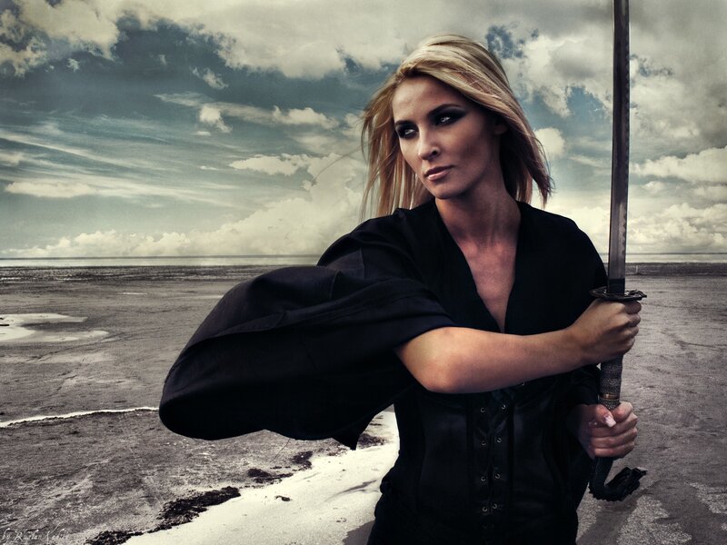 Woman with sword on beach