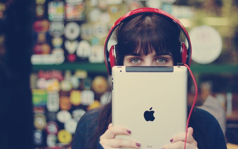 woman with tablet and headphones