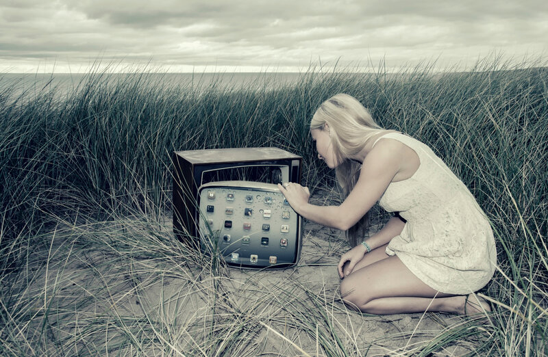 Woman with tablet in dunes