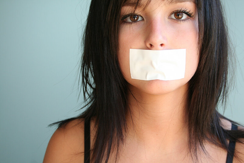 woman with tape over mouth