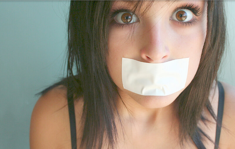 woman with tape over mouth
