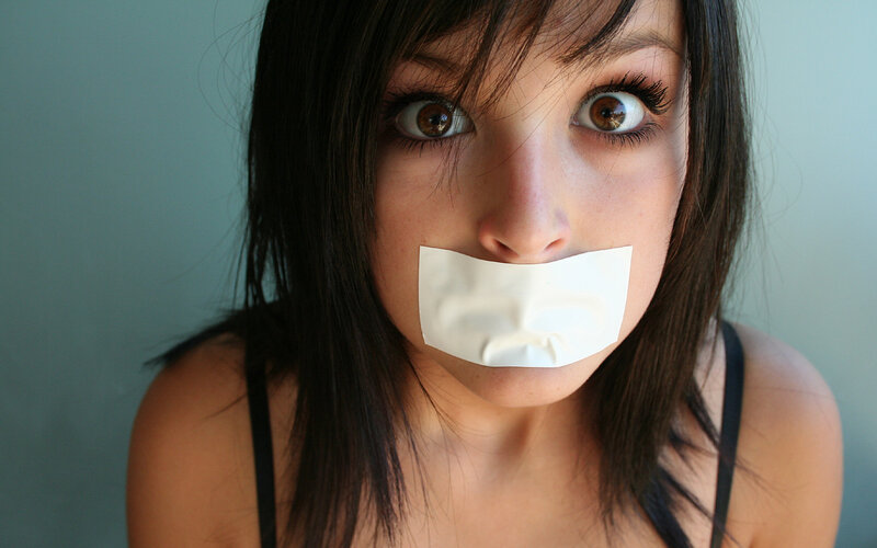 woman with tape over mouth