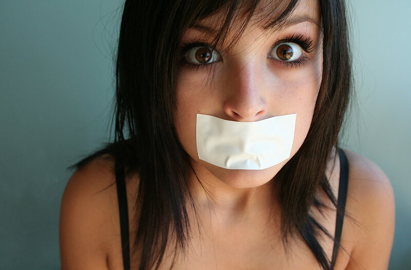 woman with tape over mouth