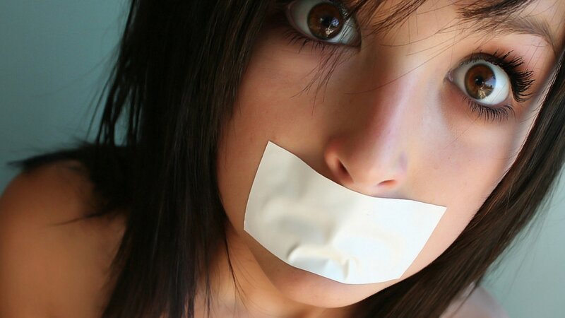 woman with tape over mouth