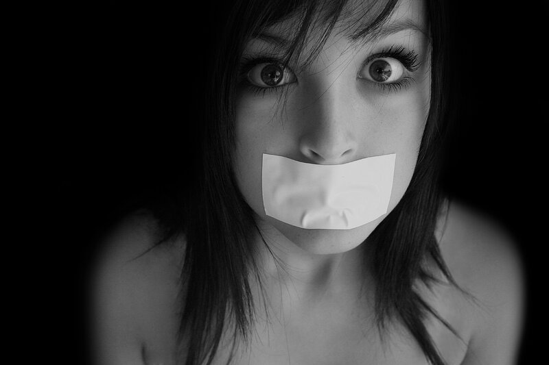 woman with tape over mouth