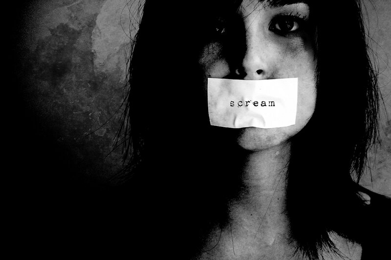 woman with tape over mouth
