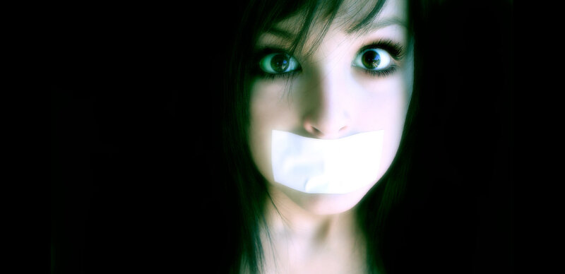 woman with tape over mouth