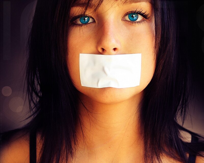 Woman with tape over mouth
