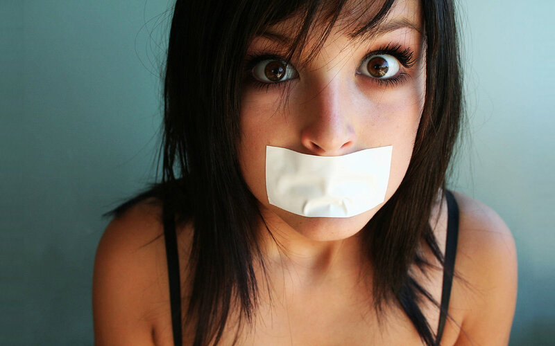 woman with tape over mouth