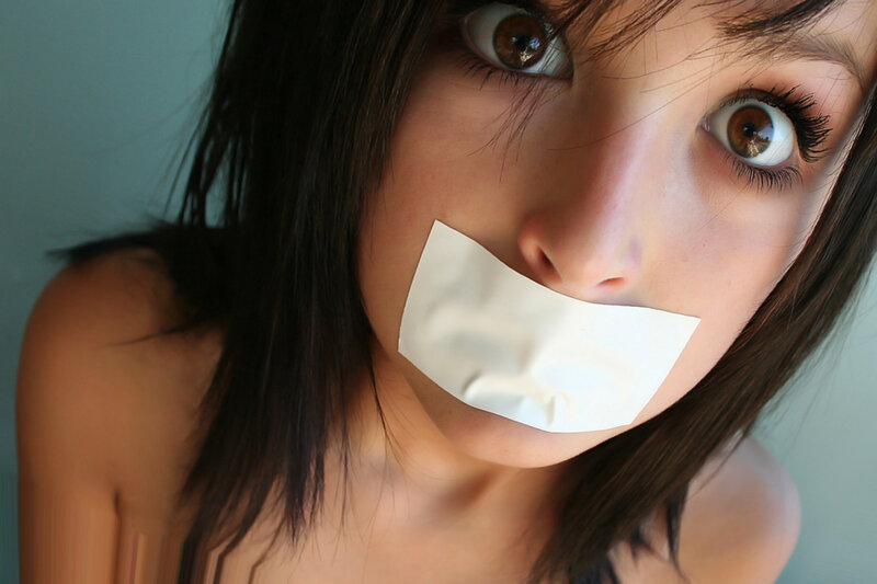 woman with tape over mouth