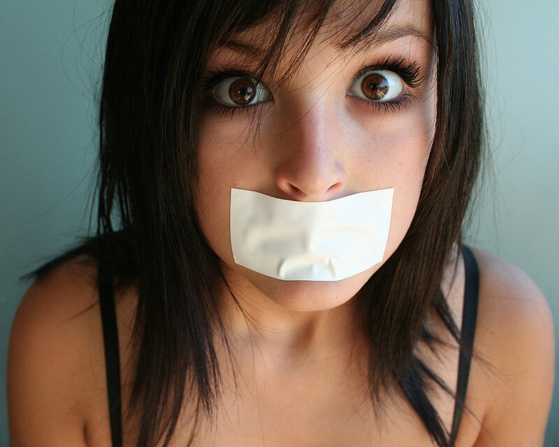 woman with tape over mouth