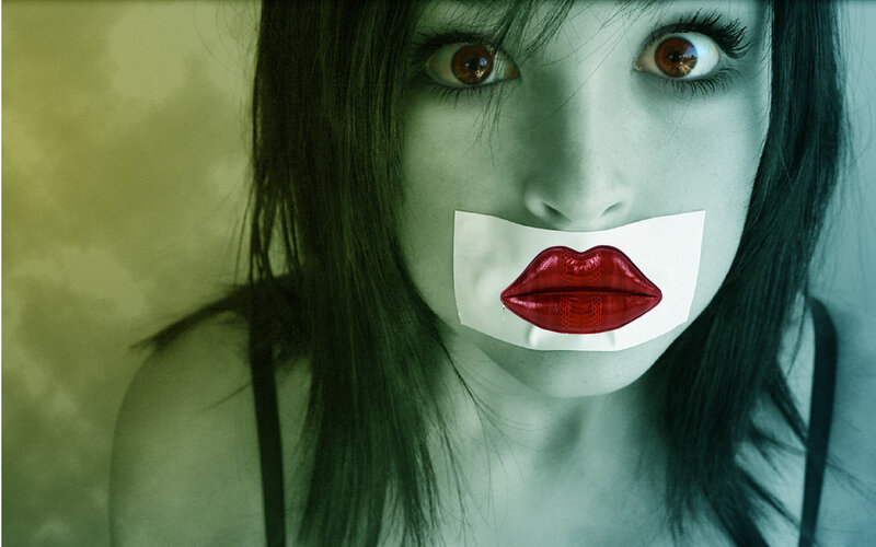 woman with tape over mouth