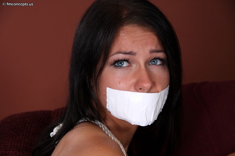 Woman with Tape over Mouth — Brown, Dramatic, Photograph, Couch