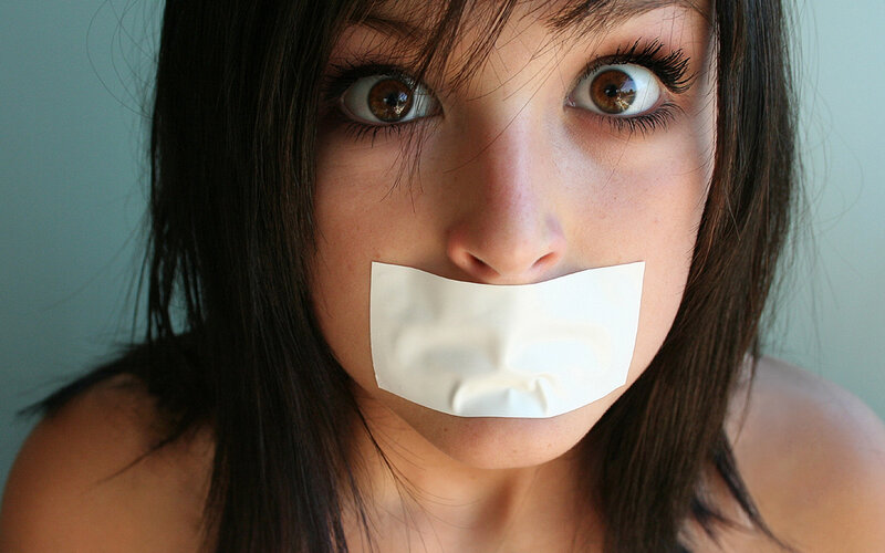 Woman with Tape over Mouth — White, Dramatic, Photograph, Eyes