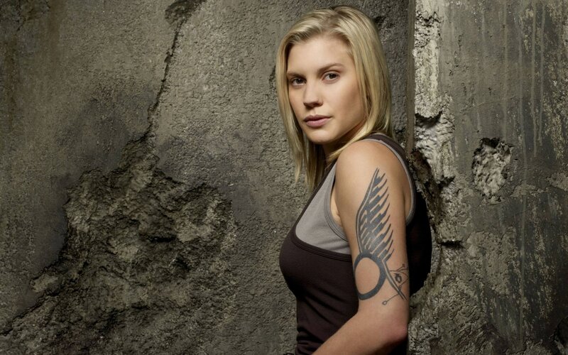 woman with tattoo against wall