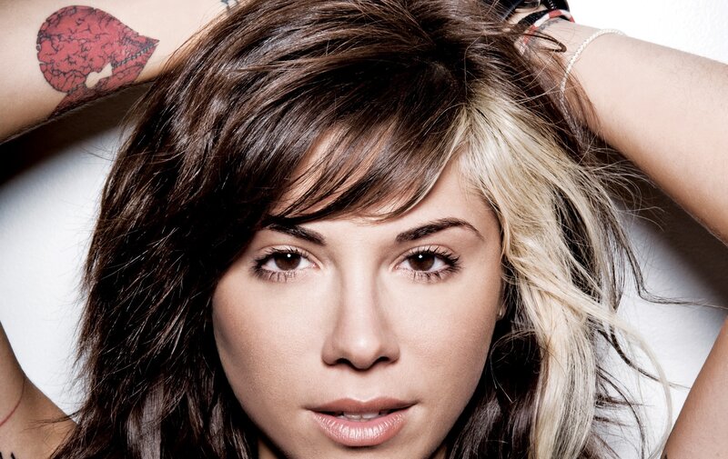 woman with tattoo and blonde highlights