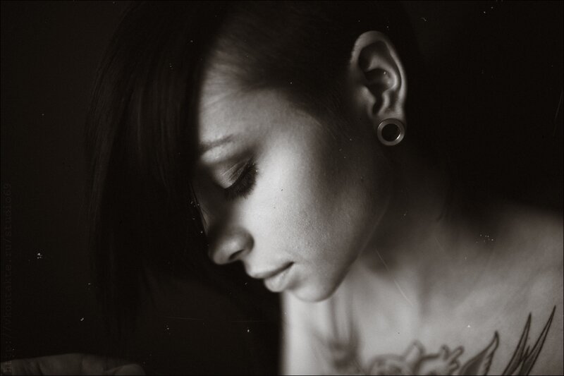 woman with tattoo and ear gauge