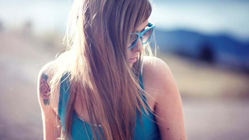 woman with tattoo and glasses