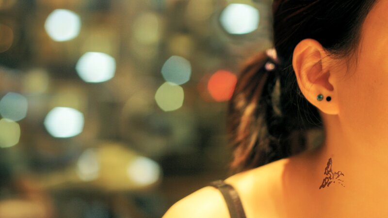 woman with tattoo at night