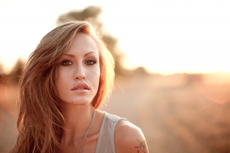 woman with tattoo at sunset