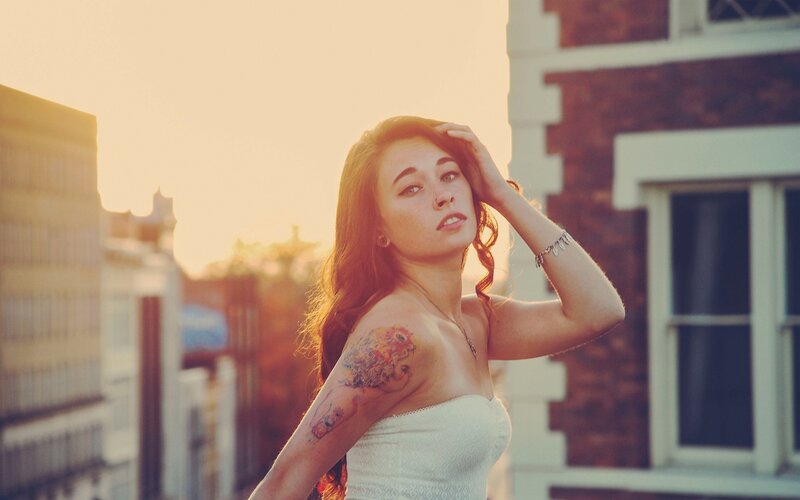 woman with tattoo at sunset