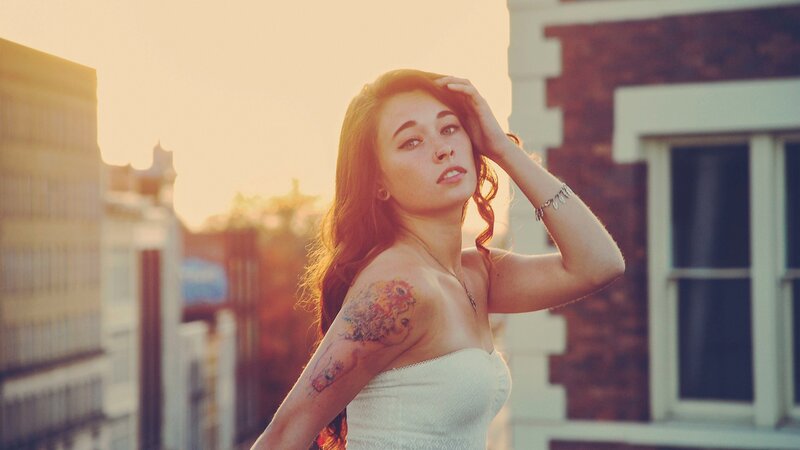 woman with tattoo at sunset