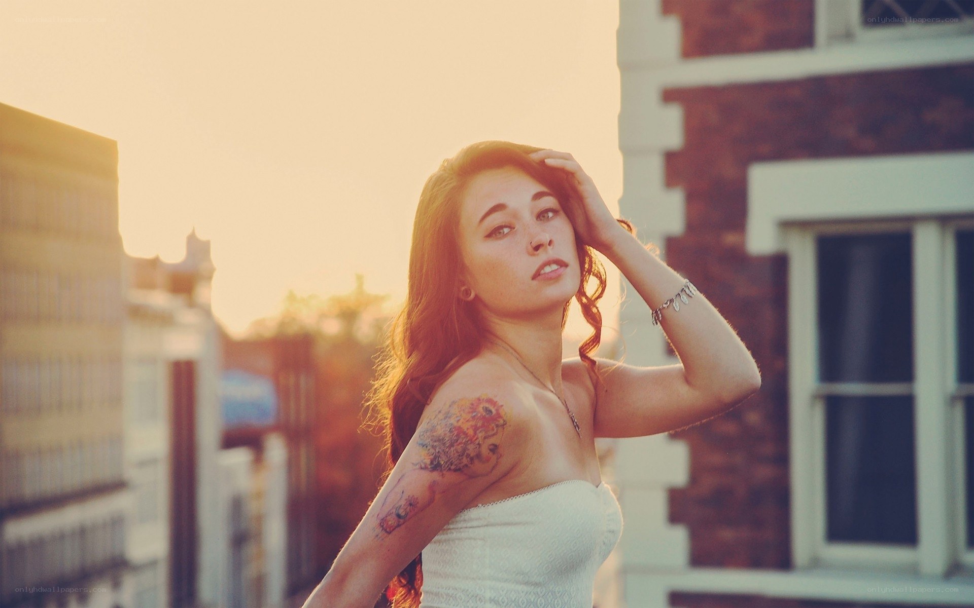 woman with tattoo at sunset