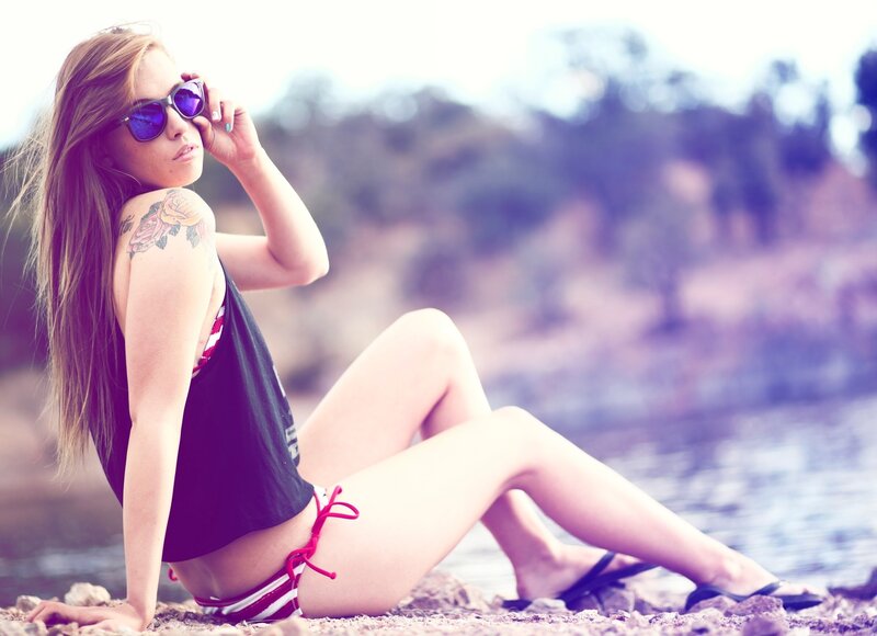 woman with tattoo at the beach