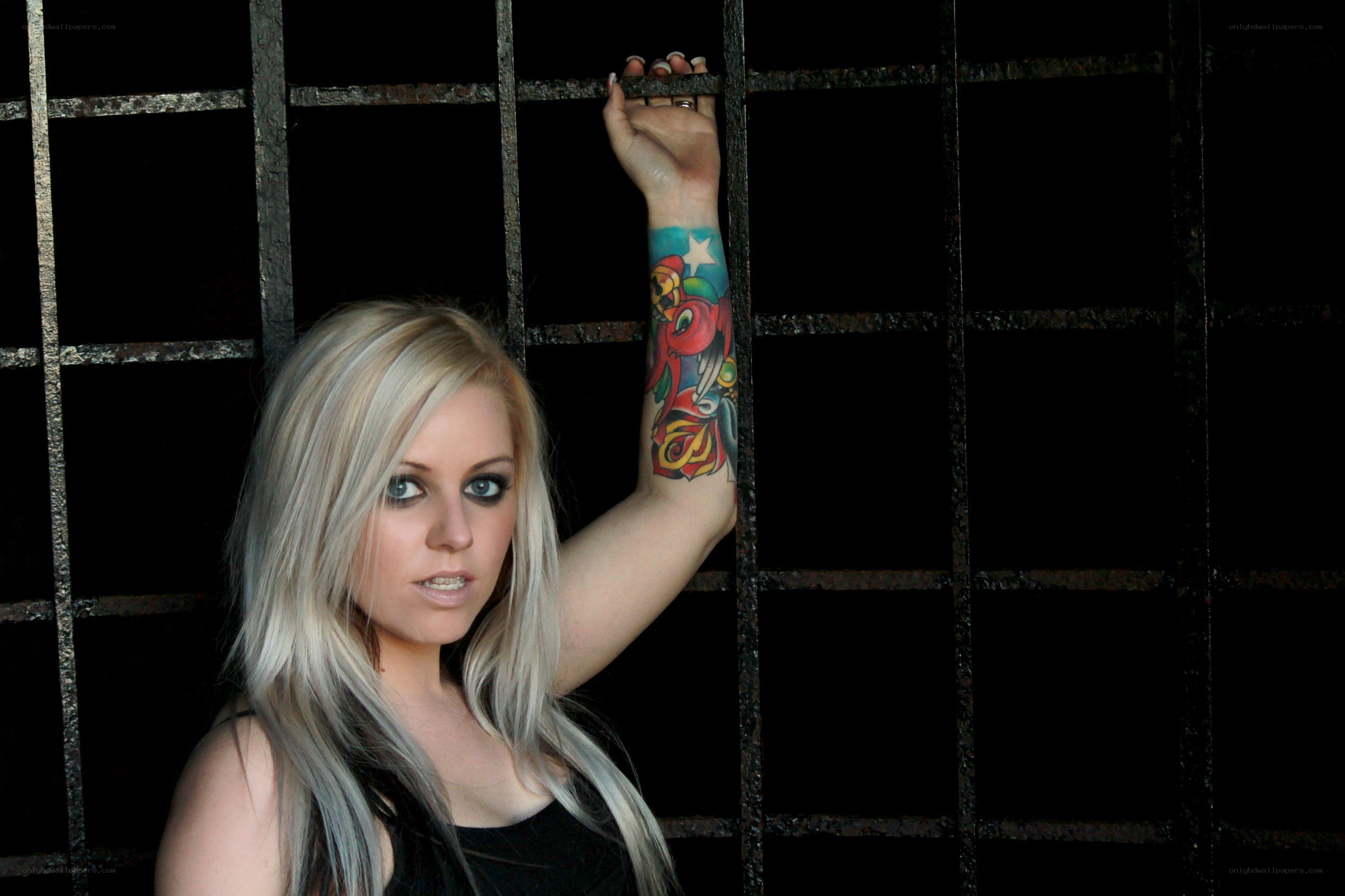 woman with tattoo behind bars