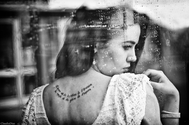 woman with tattoo behind glass